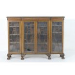 Chippendale Revival mahogany breakfront bookcase, the top with a carved edge over three astragal