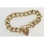 Heavy 9ct gold solid curb link bracelet, with two ring links united by a padlock clasp and safety