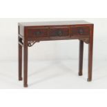 Chinese elm side table, late 19th Century, fitted with three drawers with metal ring handles, raised