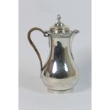 Edwardian silver hot water jug, by C S Harris & Sons, London 1904, pear shape with domed cover,