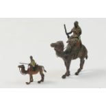 Austrian cold painted bronze figure of a bedouin riding a camel, circa 1900, 7cm; also a smaller