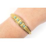 18ct yellow gold and turquoise bracelet, set with four small cabochon stones set on a banded ellipse