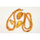 Two butterscotch amber beaded necklaces, one having a matt finish, the largest bead 15mm, length