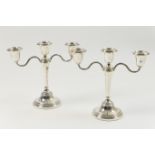 Pair of Elkington & Co. silver candelabra, Birmingham 1966/67, having three nozzles over a tapered