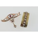 German 8ct gold jugendstil brooch, circa 1910, set with a small square cut garnet and two small