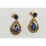 Pair of attractive sapphire and diamond pendant earrings, central pear cut sapphire of approx.