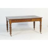 Victorian mahogany library table, circa 1870, the top with a moulded edge, black rexine writing
