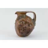 Martin Brothers face jug, dated 1903, modelled with two faces and decorated in a salt glaze,