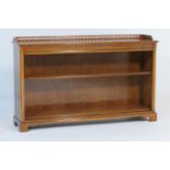 Quality modern yewood open bookcase, having a three quarter gallery back and two shelves, raised