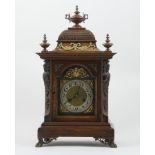 German walnut cased mantel clock, architectural case with domed top surmounted with urn finials,