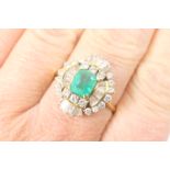Emerald and diamond cluster ring, the central step cut emerald of approx. 1ct, 6mm x 5mm, bordered