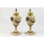 Pair of French ormolu mounted marble cassoulet urns, with flame finial, rams mask and floral garland