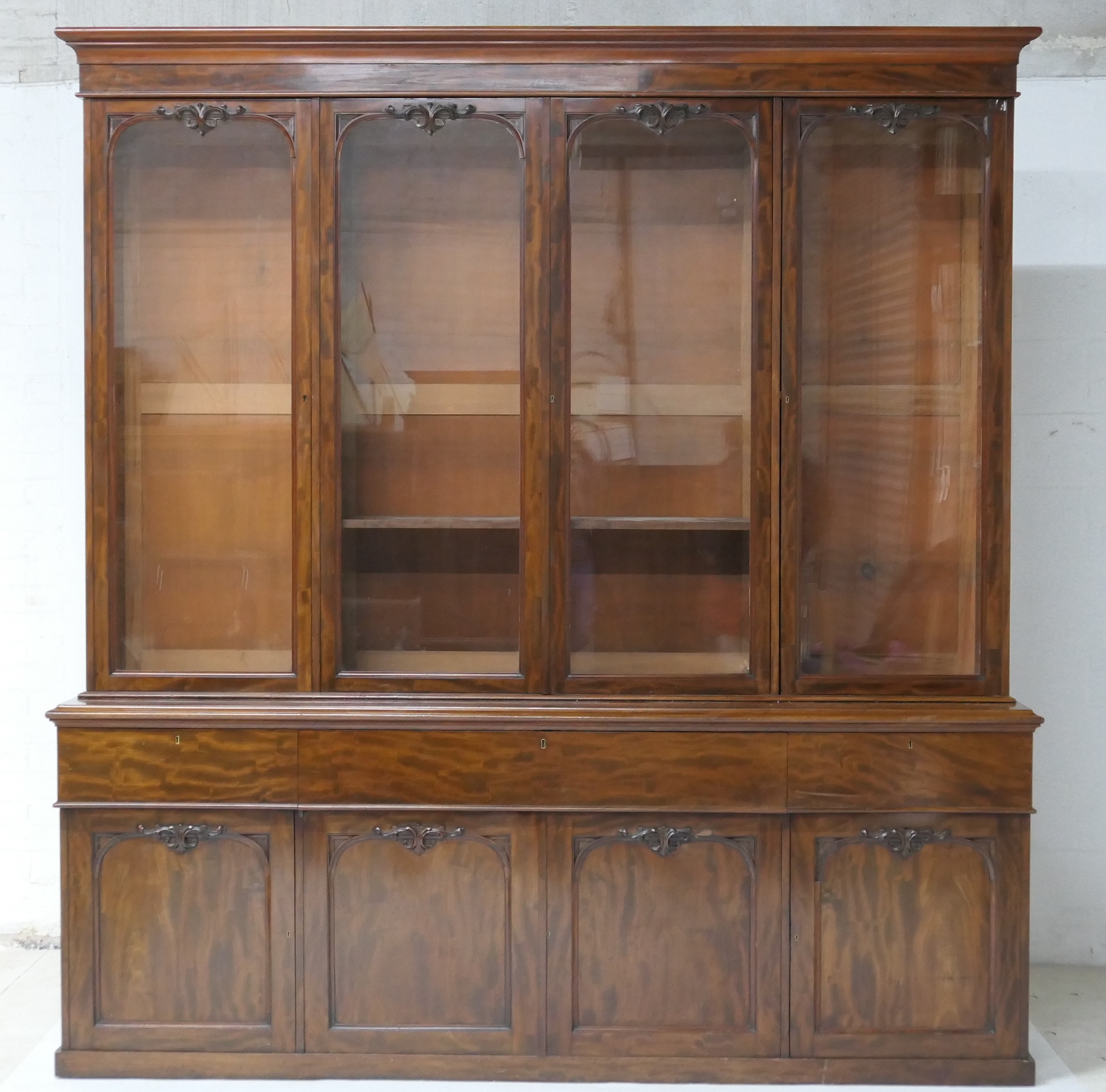 Early Victorian mahogany secretaire library bookcase, circa 1840, having a cavetto moulded cornice