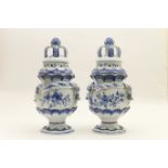 Pair of delft blue and white pot pourri jars, traditional form with pierced cover with bud and