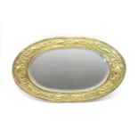 Newlyn style hammered brass framed oval wall mirror, circa 1900-10, worked with fishes swimming