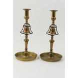 Pair of Victorian brass tavern candlesticks, circa 1840-60, each centred with a bell over a