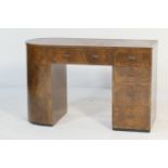 Art Deco walnut kneehole desk, asymmetrical form with a curved end with two cupboard doors opening