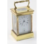 French brass carriage clock, with alarm, white dial with Roman numerals, signed and with