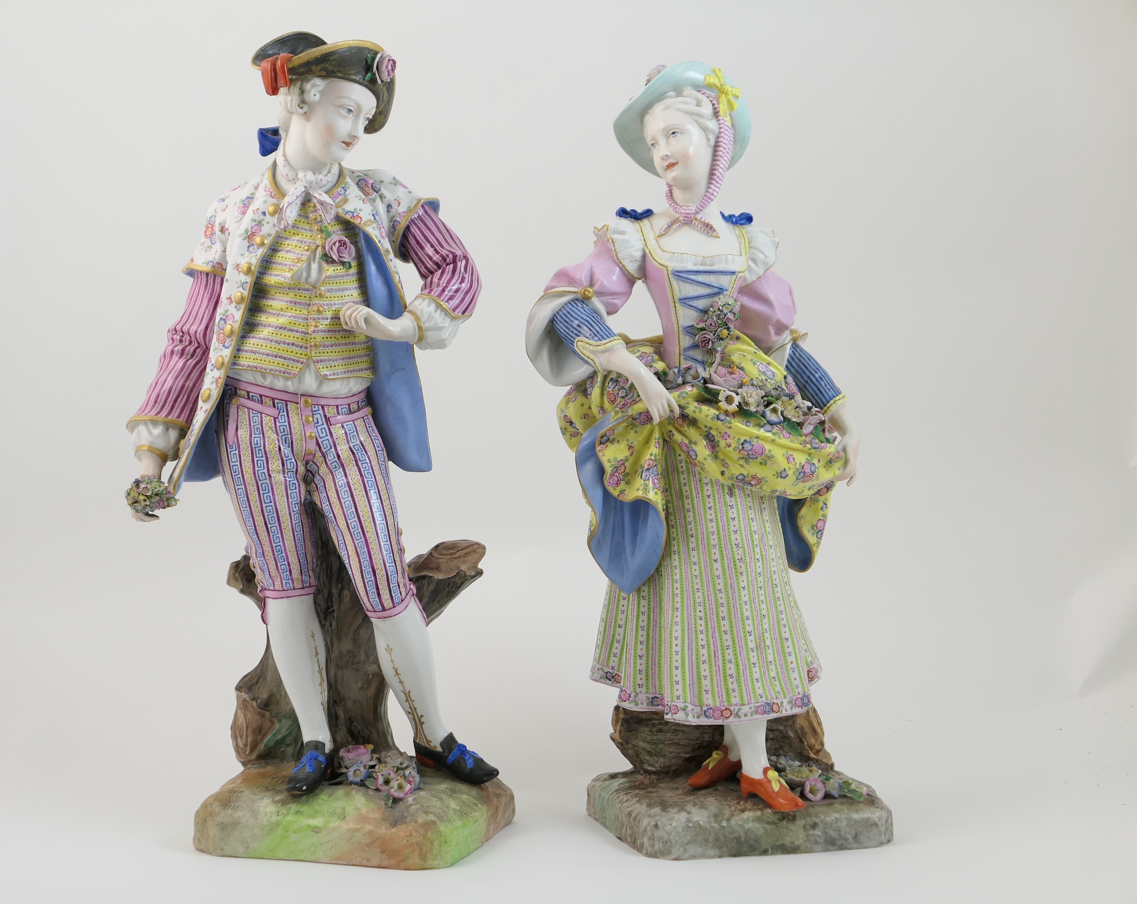 Pair of Dresden porcelain figures of gardeners, after Meissen, circa 1870, each modelled in 18th