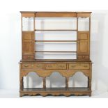 Oak dresser and plate rack, the rack 19th Century with three central shelves flanked by two cupboard