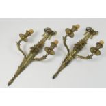 Pair of French cast brass twin branch wall lights, in the French Republic style, cast as a