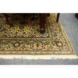 Kashan woollen carpet, having a fawn field with a sky blue central medallion dispersed with