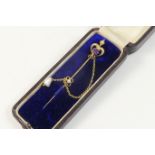 Edwardian 15ct gold amethyst and pearl stick pin, central amethyst set within a fleur-de-lys style