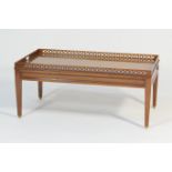 Modern yewood galleried coffee table, rectangular form raised on tapered square section legs with