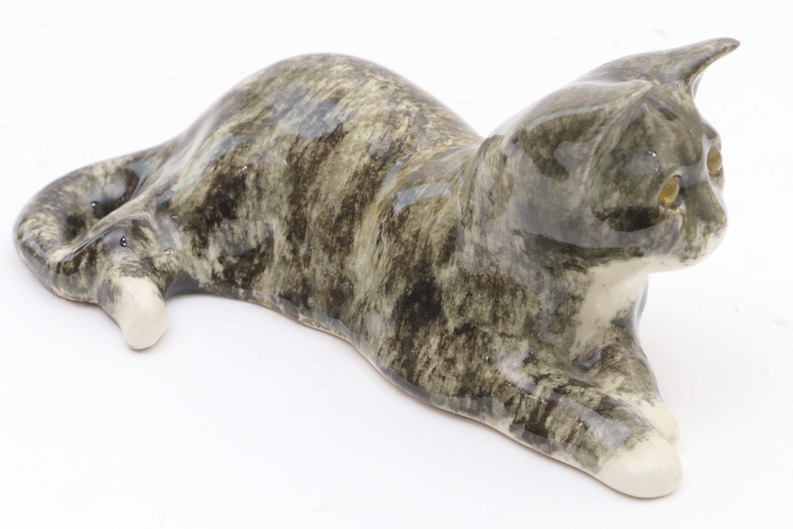 Winstanley pottery tabby cat, modelled recumbent, signed, 26cm