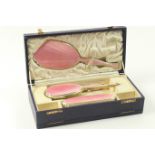Pink enamelled silver gilt vanity set by J C Vickery, Chester 1931/32, comprising hand mirror,