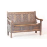 Oak joined box settle, 19th Century, guilloche carved four panel back with a frieze carved with