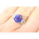 Tanzanite and diamond three stone ring, the oval cut stone of approx. 2cts, 9mm x 8mm, in a four