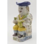 French faience toby jug, in the style of Quimper, traditionally modelled and decorated with yellow