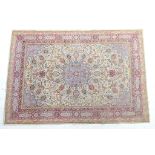 Kashmir rug, fawn field centred with a sky blue medallion and sky blue spandrels within a red