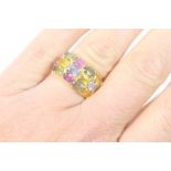 18ct gold multi gem set dress ring, set with fifteen oval cut coloured gems in a pave setting, on