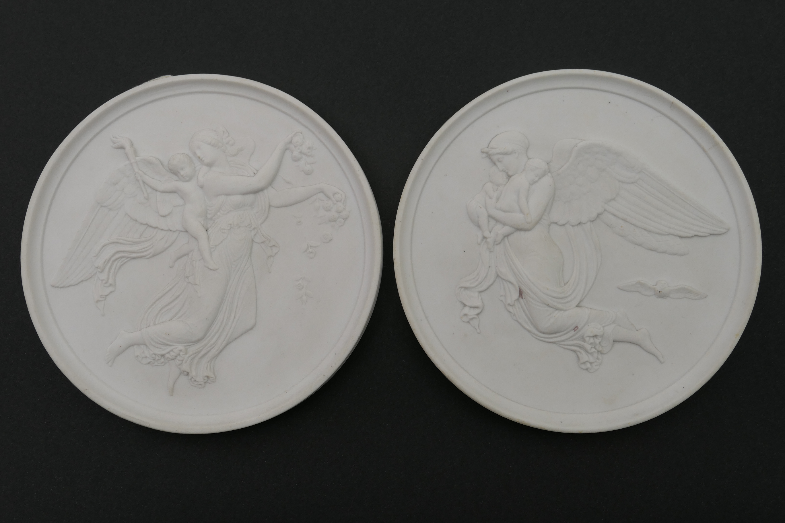 Pair of Eneret relief moulded porcelain plaques, emblematic of Night and Day, impressed marks, 14.