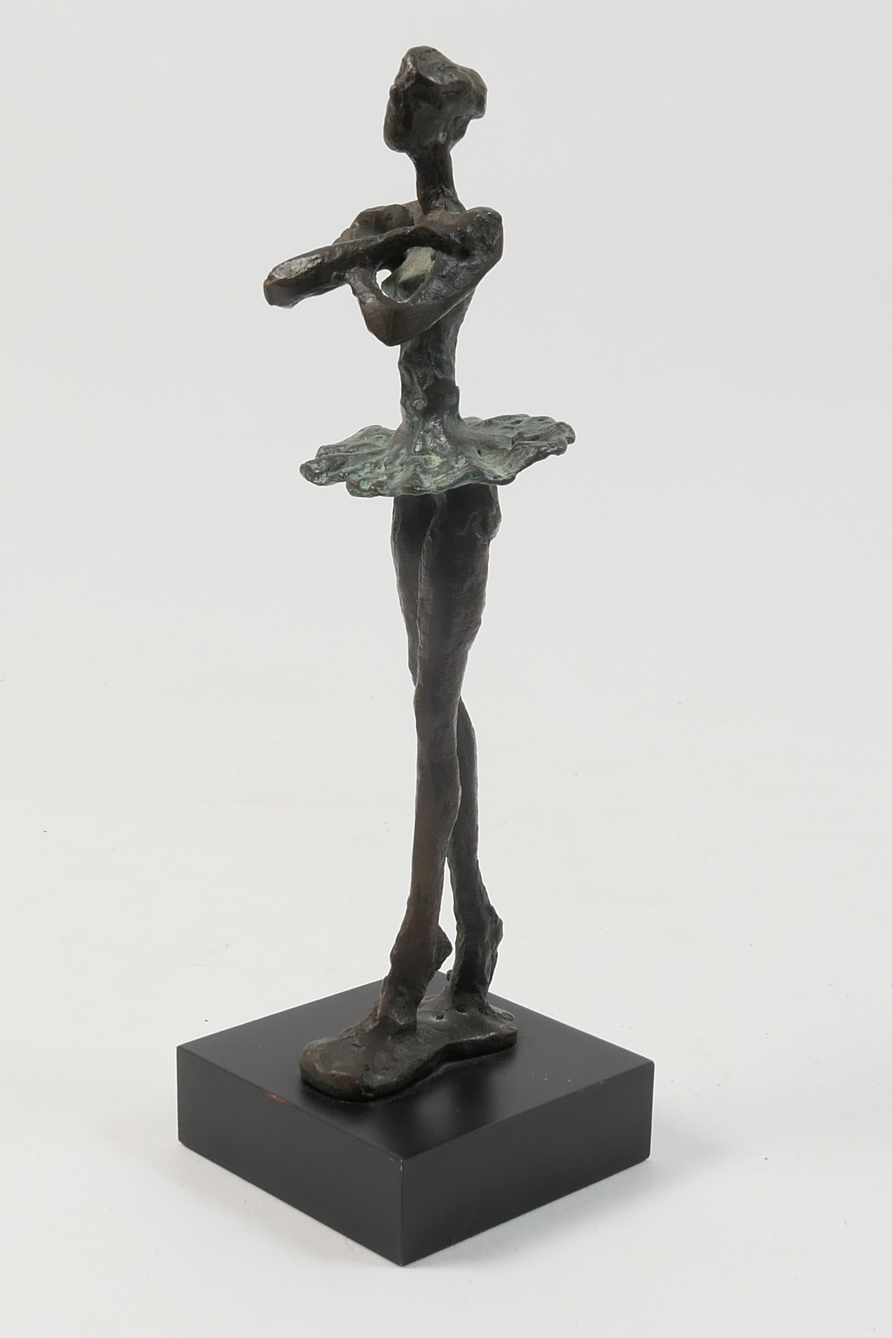 Decorative modernist cast metal sculpture of a ballet dancer, on pointe, 23cm, mounted on a black