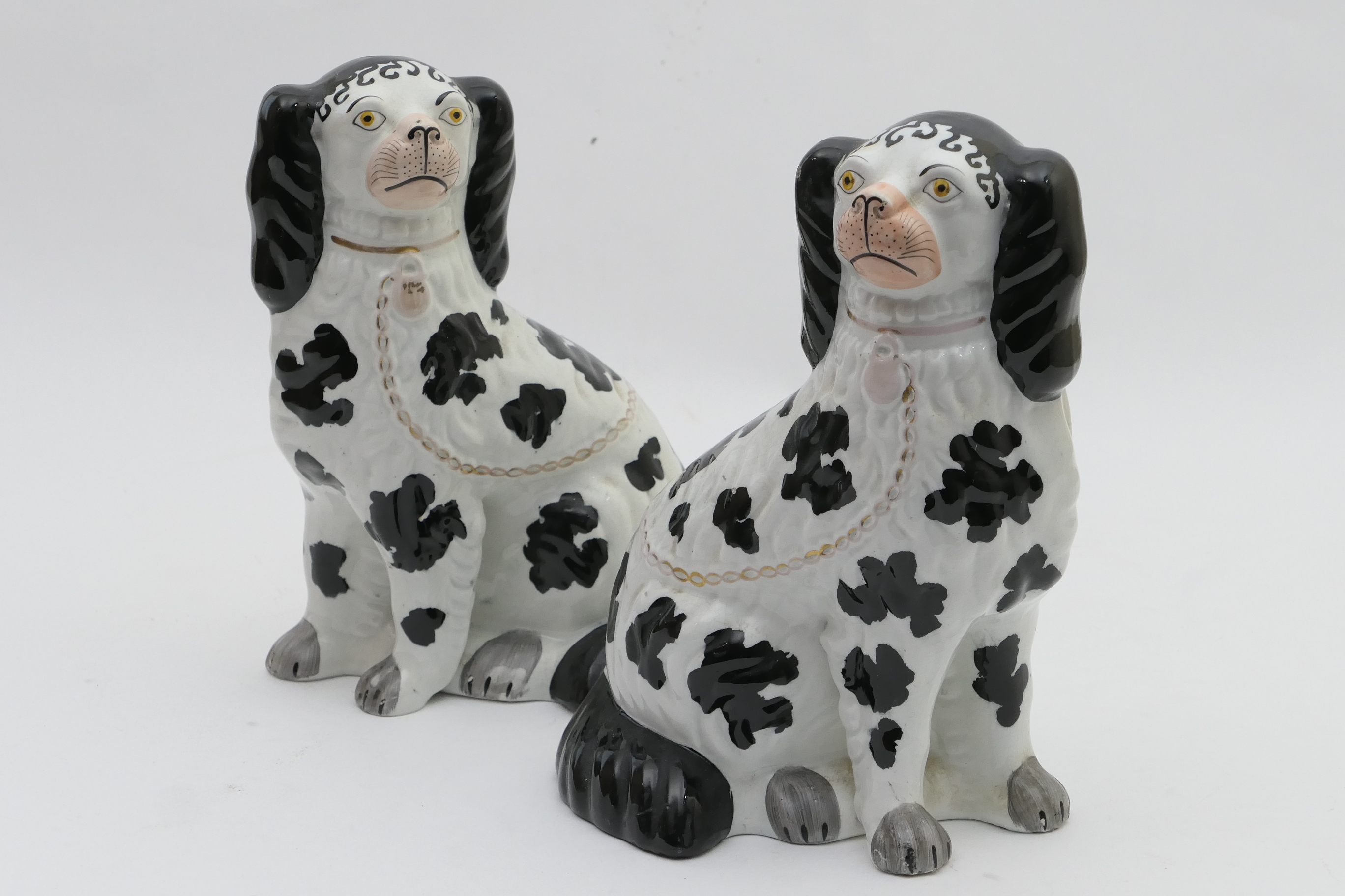 Pair of Victorian Staffordshire spaniels, circa 1870, finished in black and white glazes, height