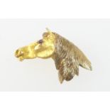 9ct gold horse's head brooch, hallmarked Birmingham 1990, having cabochon ruby eyes and chased mane,
