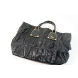 Prada leather handbag, black ruched leather with gold tone accents, twin handles, maker's logo to