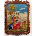 Victorian needlework tapestry 'Charity', glazed and mounted within a carved shell and scrolling