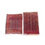 Turkman Bokhara woollen rug, having three rows of guls against a dark brown ground, size approx.