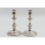 Pair of silver candlesticks, in the Queen Anne style, London 1962, with multi-knopped column over