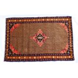 Iranian woollen rug, brown field centred with a red and black stepped medallion within a burgundy