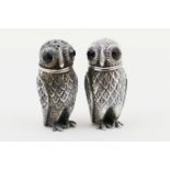 Pair of Continental 800 standard silver owl form condiments, each having claret red glass eyes,