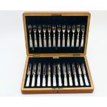 George V oak cased canteen of silver plated and mother of pearl handle dessert knives and forks,