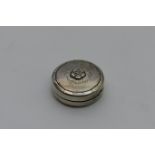 Georg Jensen silver pill box, no. 79C, hammered circular form centred with a rose head design,