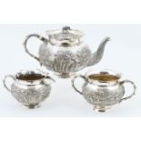 Burmese white metal three piece tea service, circa 1900, comprising teapot, milk jug and sugar