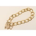 9ct gold solid curb link bracelet, with padlock clasp and safety chain, weight approx. 37.3g
