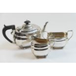 George V silver three piece tea service, Chester 1930/31, comprising teapot with ebony finial and